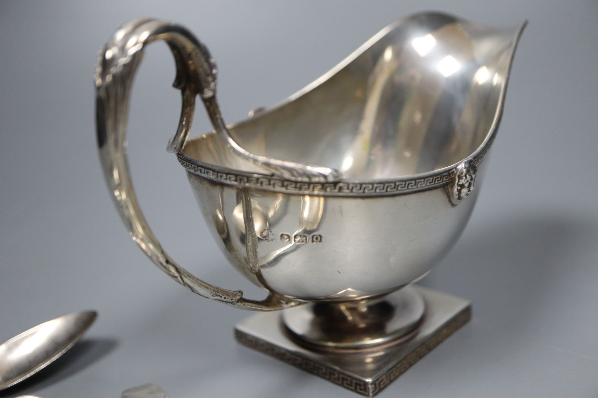 A George V silver sauceboat, a French white metal goblet(repaired) and seven assorted 19th century silver teaspoons,